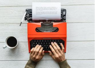 hands at a typewriter